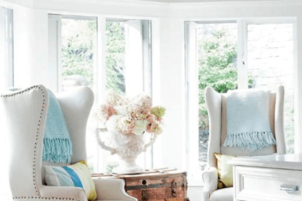 A photo of the inside of the Kelowna home once owned by Jillian Harris. It features white bow windows and a seating area.