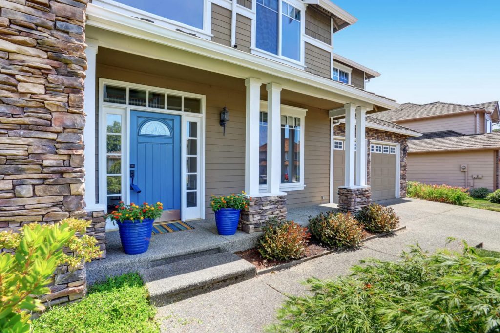 Home with a blue front door and white windows.
