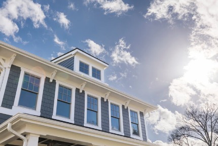 Exterior view of a house with lots of windows.